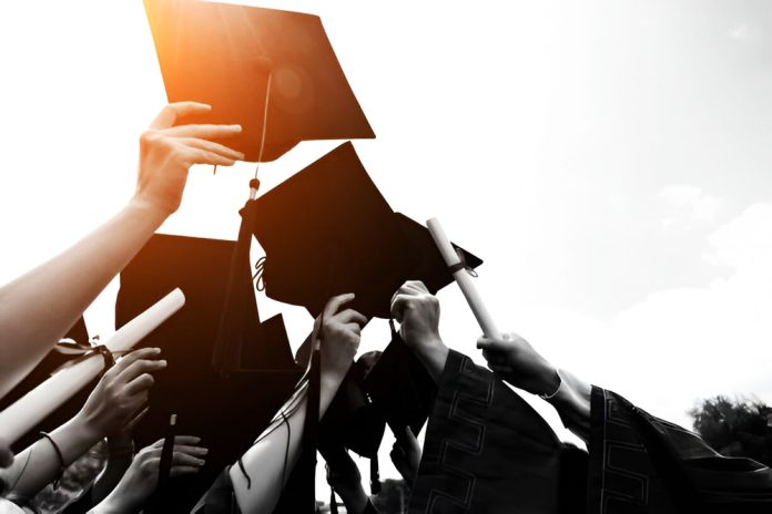 Group,Of,Graduate,Students,Throwing,Graduation,Hats,To,The,Sky.